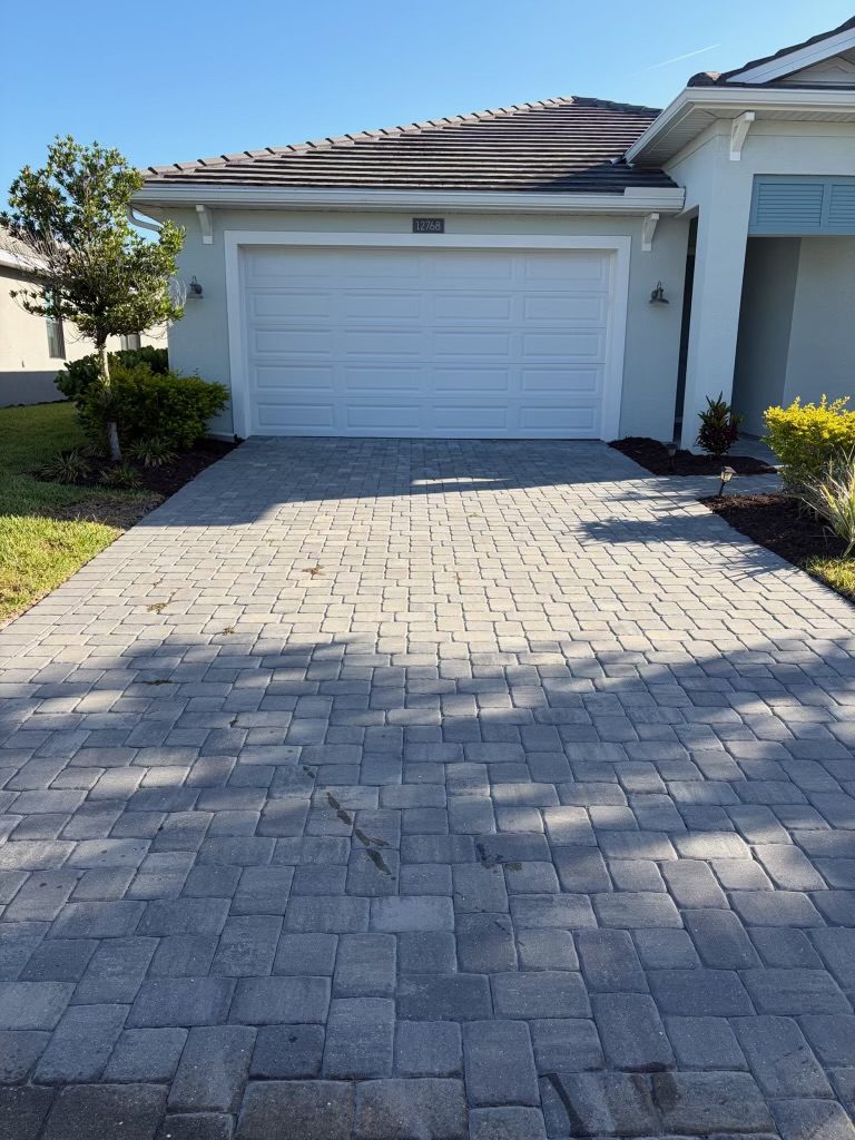 The same driveway before washing, grey and dull
